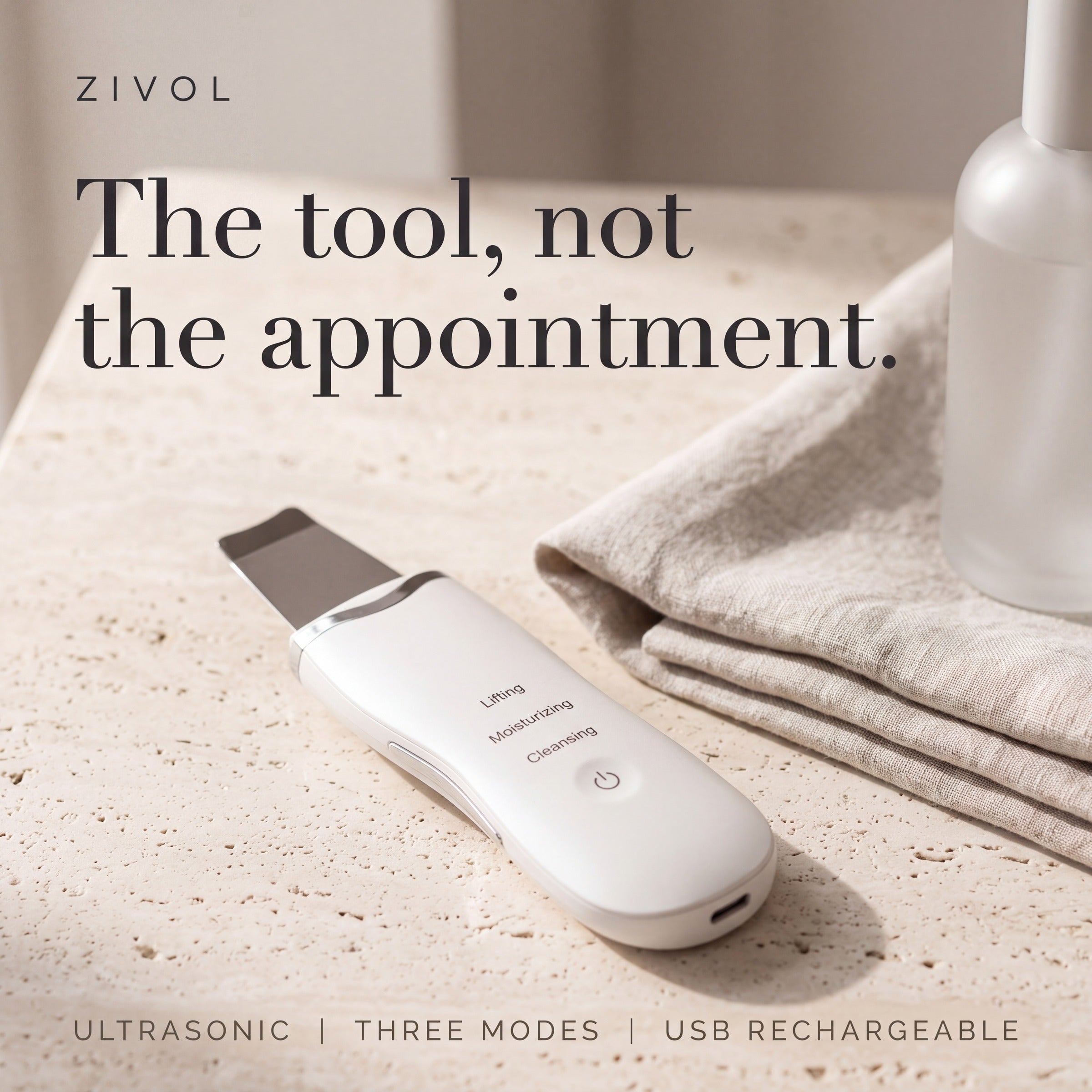 Zivol Glide ultrasonic skin spatula on travertine — the tool, not the appointment