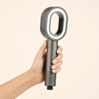 Zivol Pure shower head held in hand — the head is about the width of a palm
