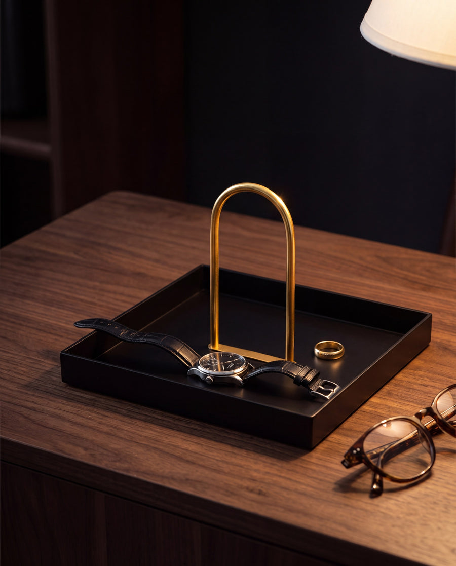 Zivol Arc square tray with polished brass arch holding a watch on a walnut desk