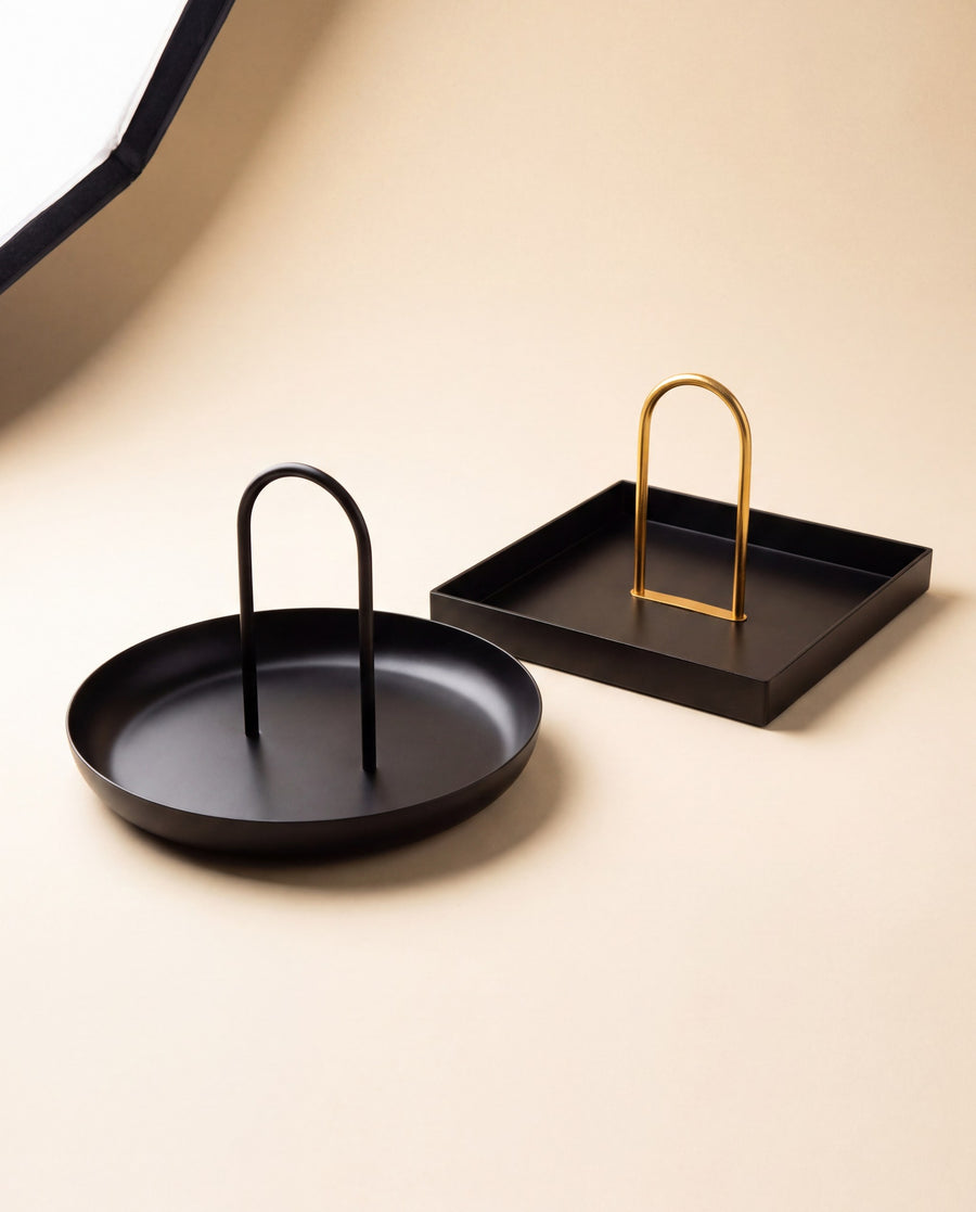 Zivol Arc round black tray and square brass tray shown together as a pair