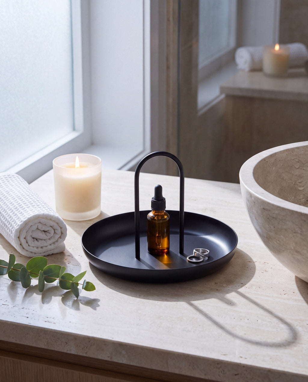Zivol Arc tray with face oil and a candle on a travertine bathroom counter