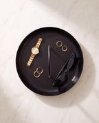 Overhead view of the Zivol Arc tray holding a watch, rings and sunglasses