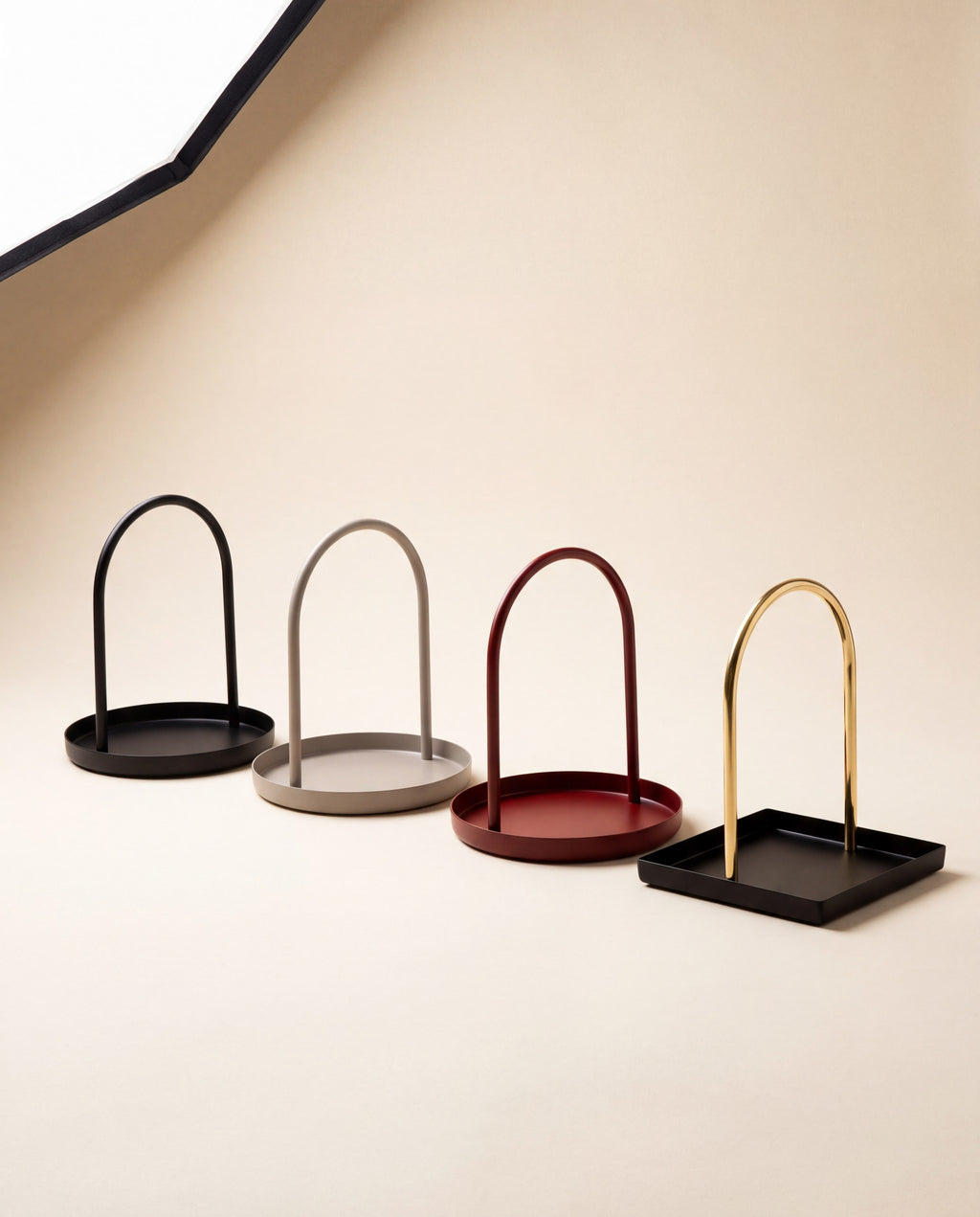 The four Zivol Arc finishes shown together: black, warm grey, oxblood red and black with brass arch