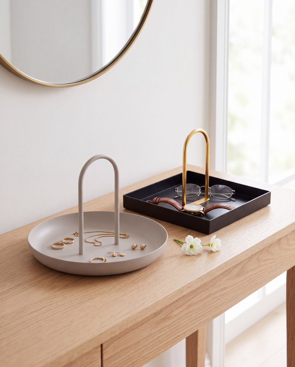 Zivol Arc warm grey tray and black tray with brass arch shown as a pair on an oak console