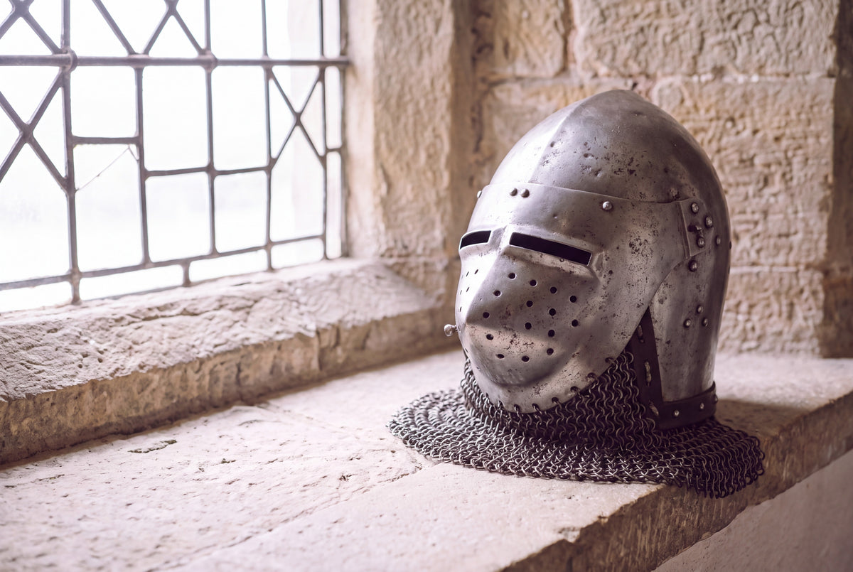 A bascinet, a medieval helmet of about 1380, on a stone window sill.