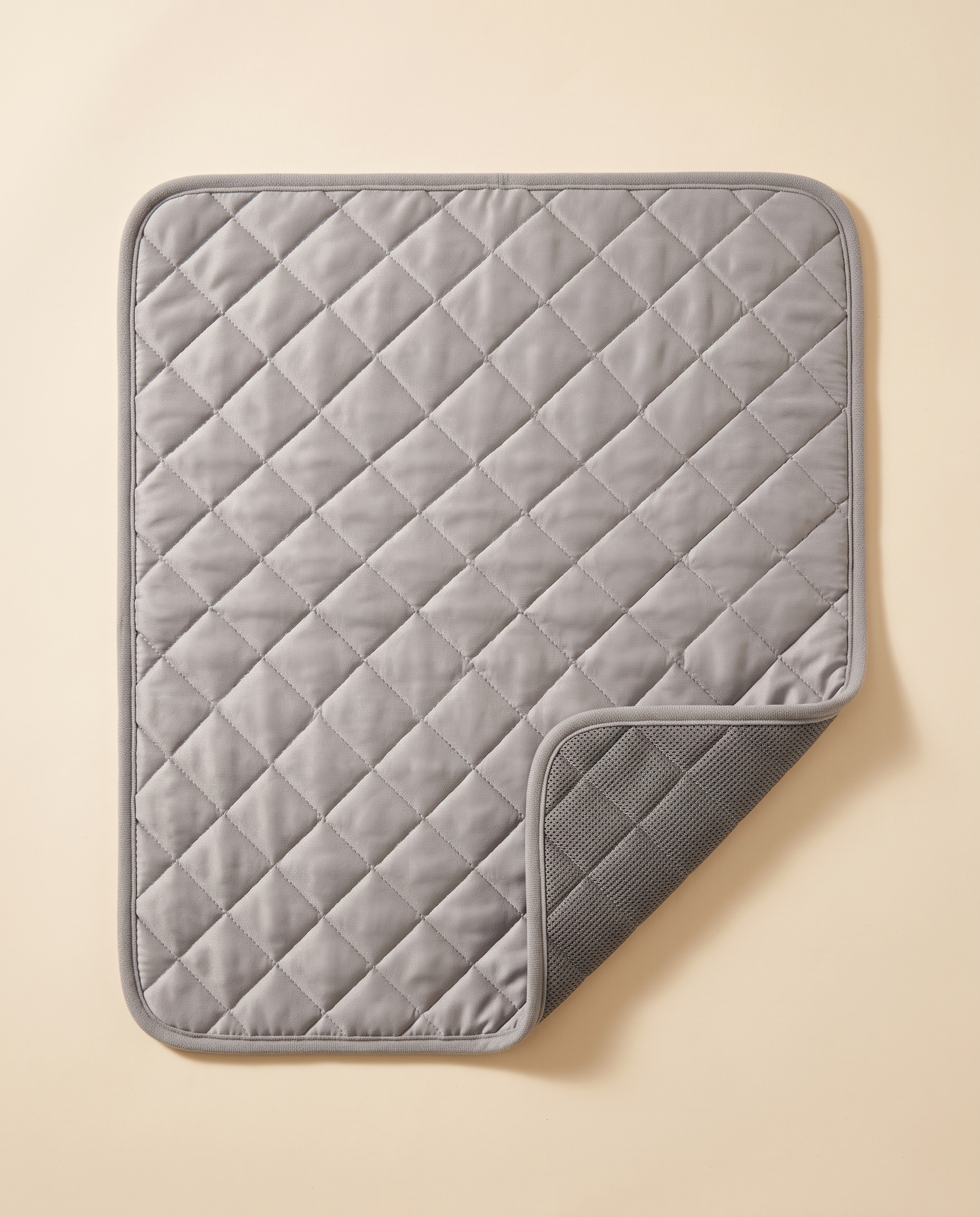 Zivol Cool grey quilted pet cooling mat shown flat with folded corner revealing the non-slip base