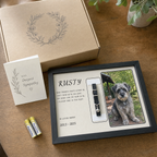 Zivol Echo beside its kraft gift box, sympathy card and included AA batteries
