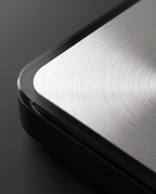 Brushed metal platform meeting tempered glass, close detail