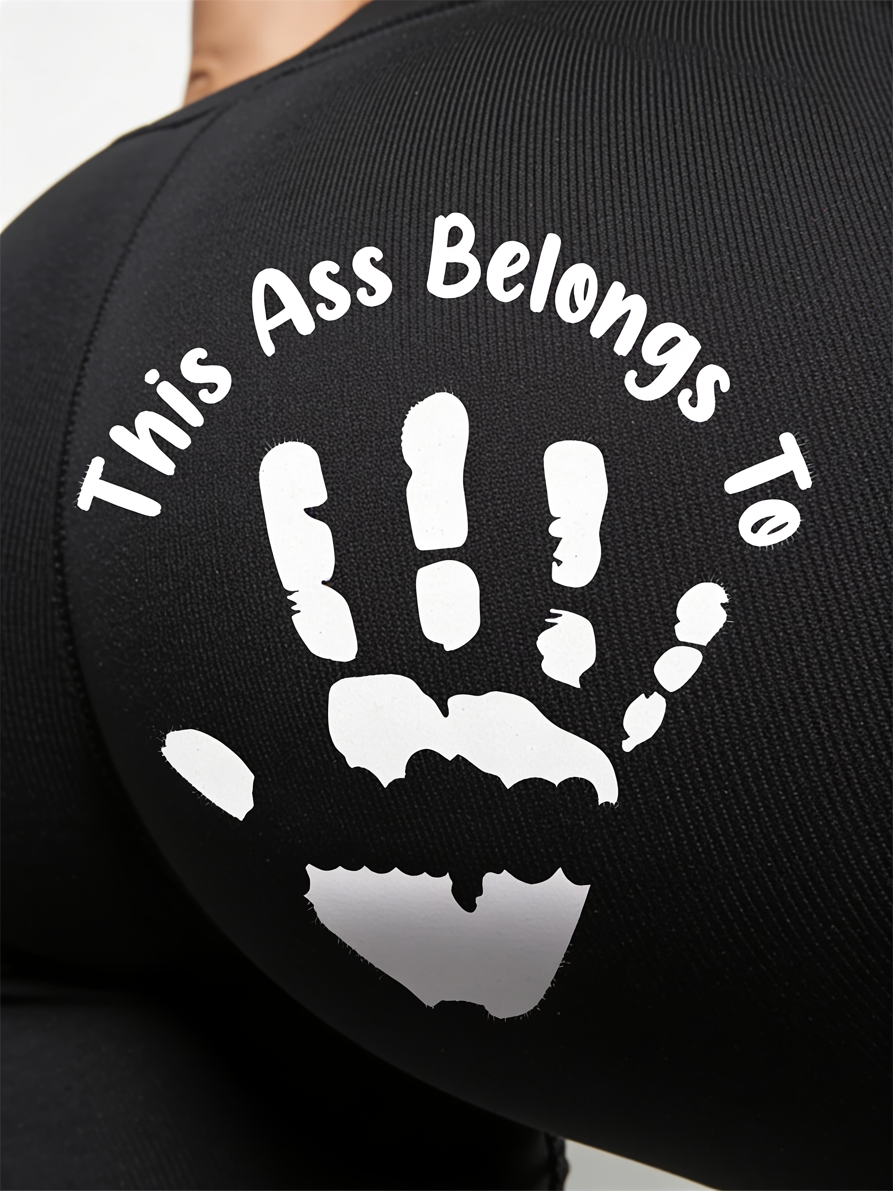 Close-up of the white handprint print on black knit fabric