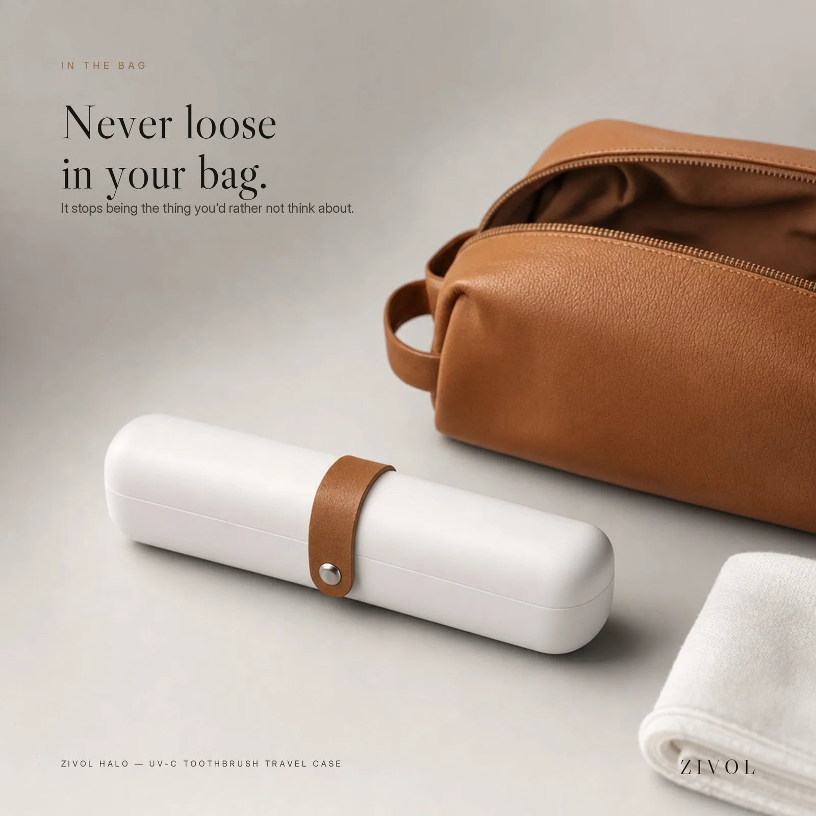 Zivol Halo UV-C toothbrush travel case packed beside a leather wash bag