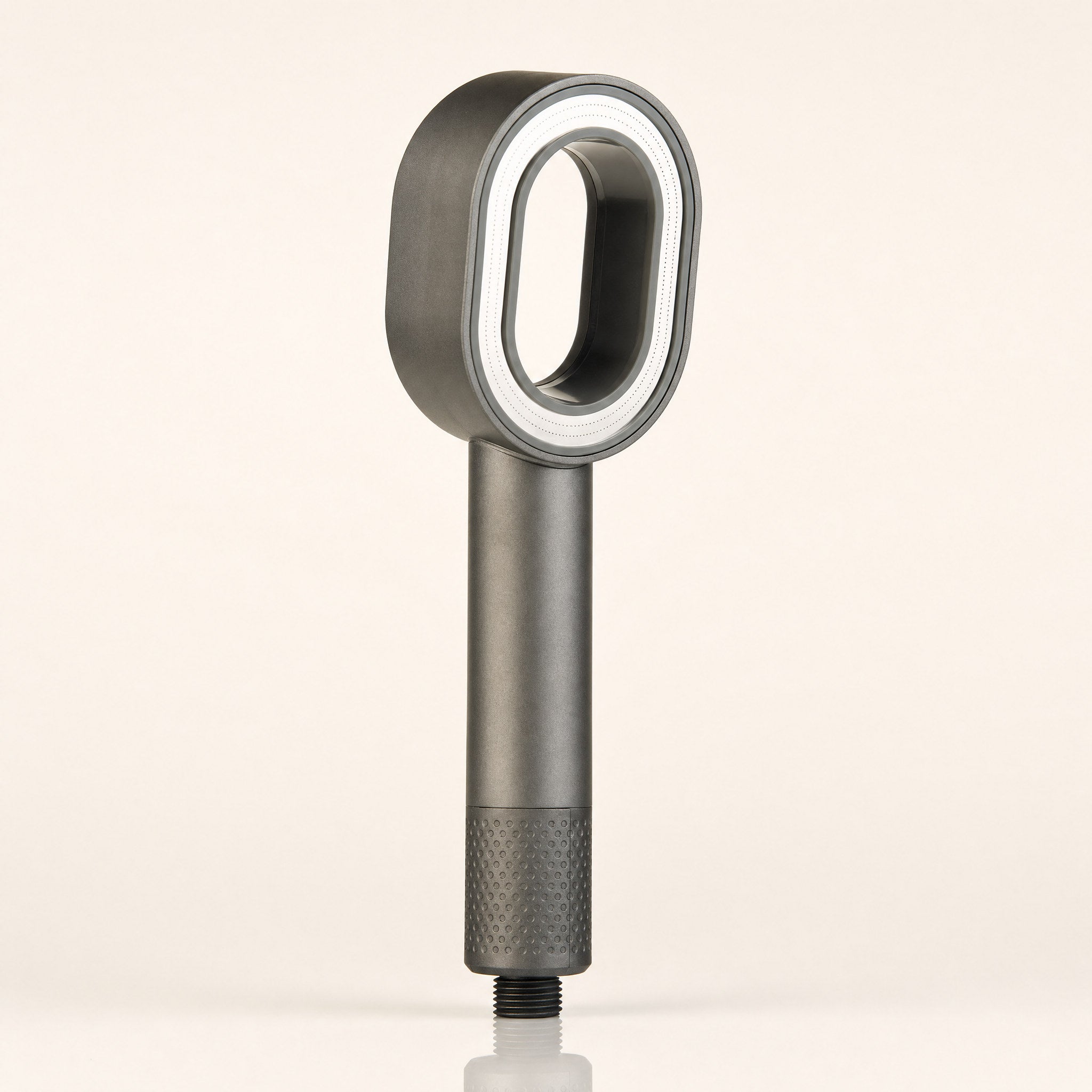 Zivol Pure filtered shower head in Graphite Grey, standing upright on a warm neutral background