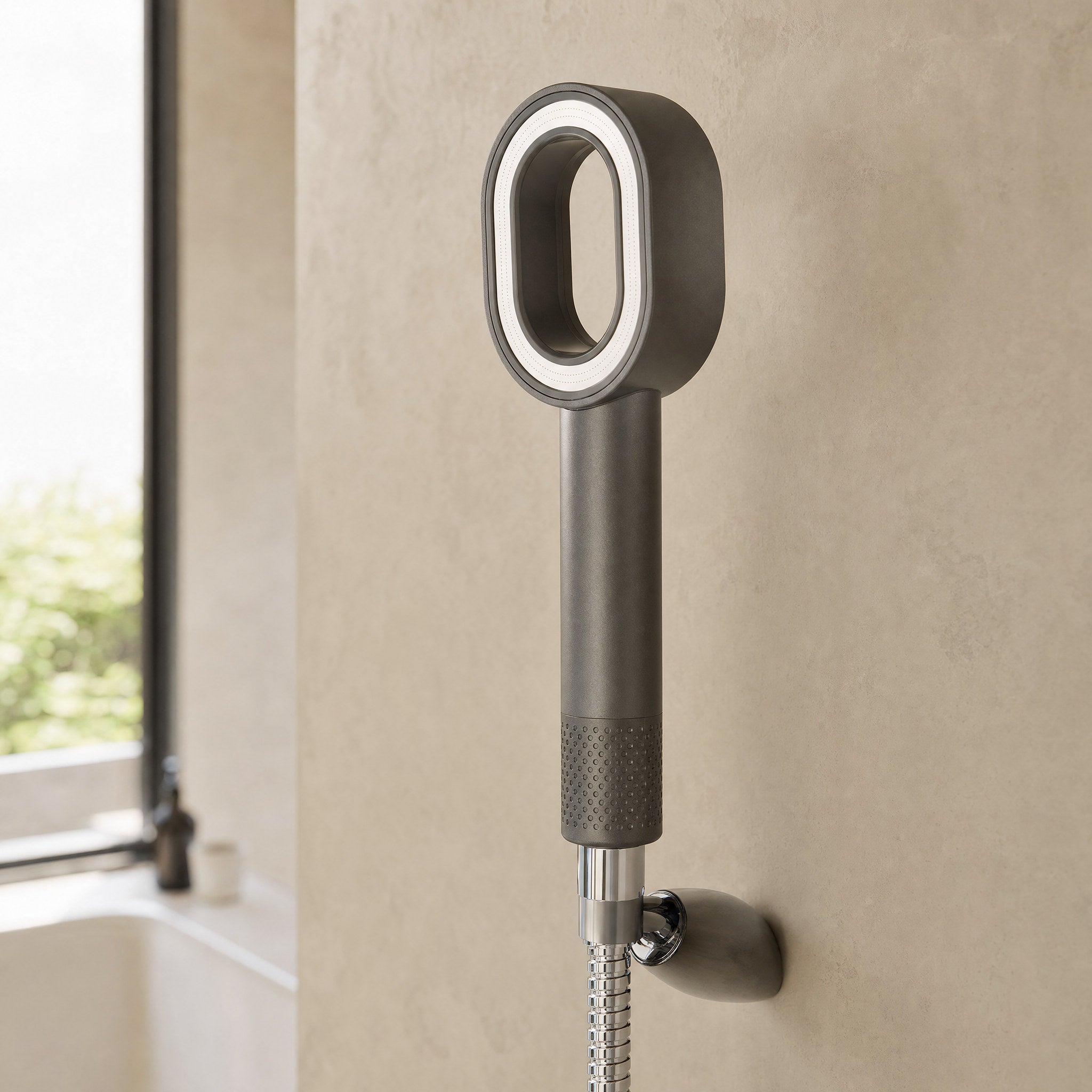 Zivol Pure shower head fitted to a chrome hose in a modern bathroom